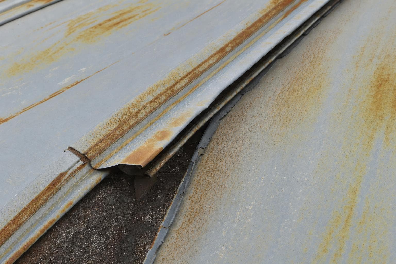 Panel, seam, fastener, coating, or substrate conditions that cannot be restored locally