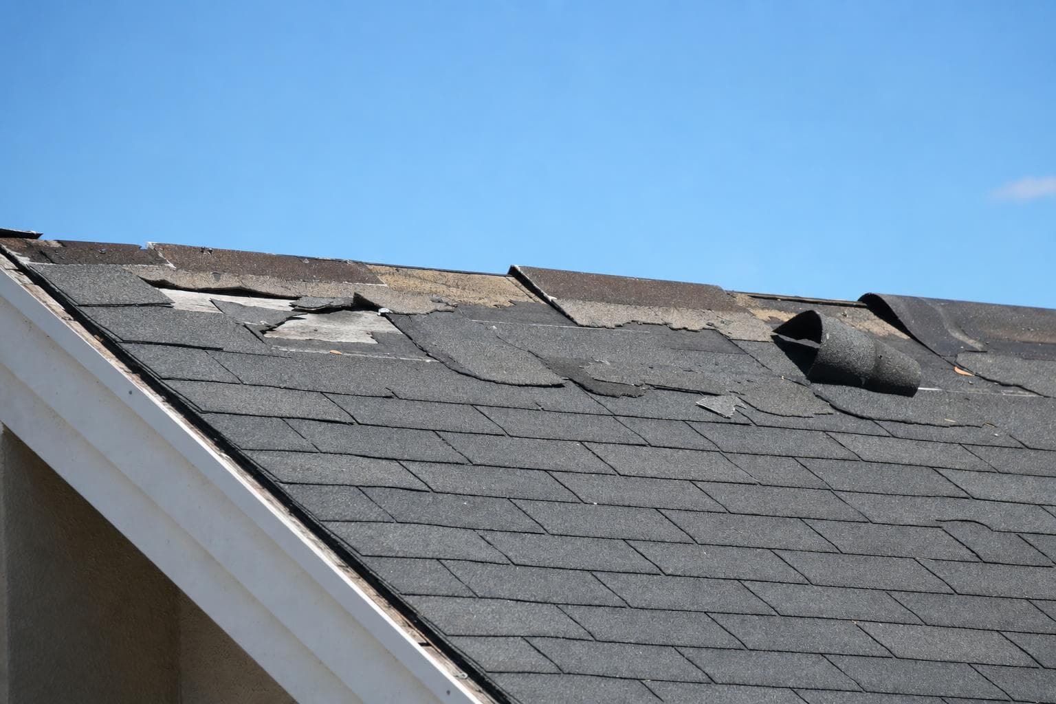 Attachment or edge failure repeated across slopes, ridge, rakes, or eaves
